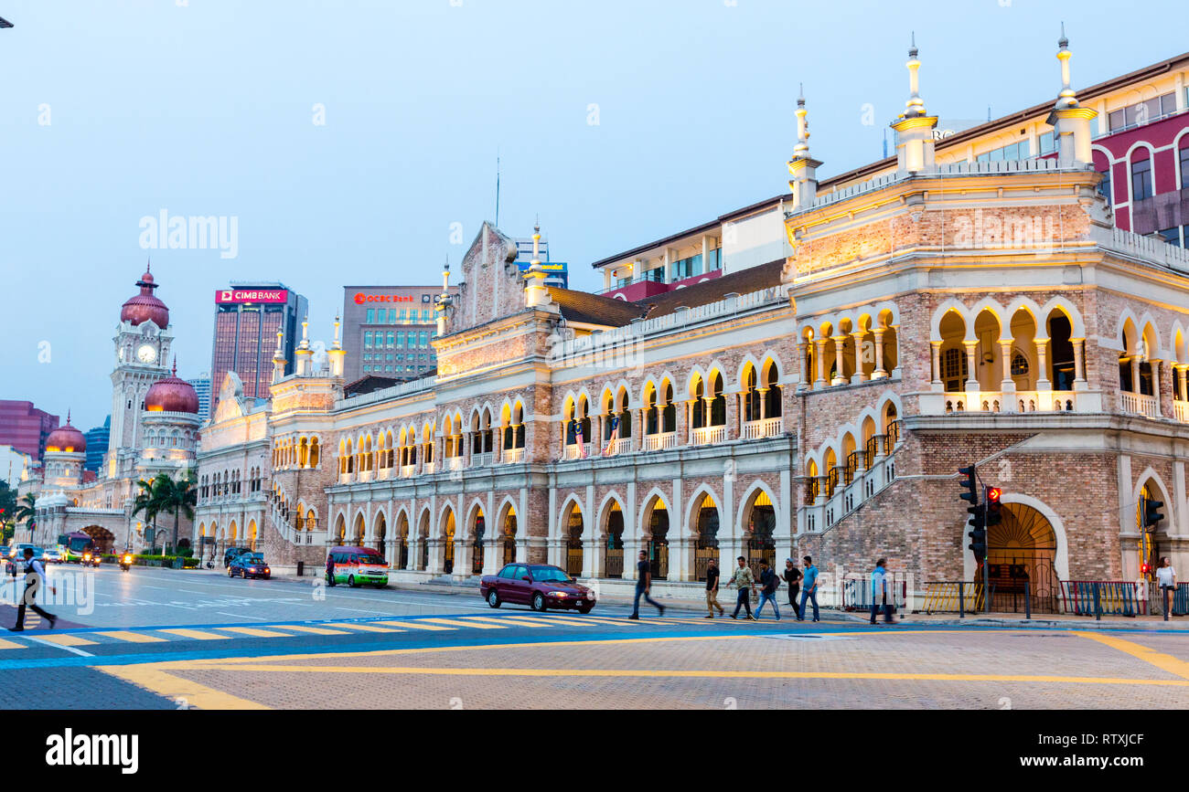 Moorish Architecture on Jalan Raja Street.  Catholic Church and Sultan Abdul Samad Buildings in distance, early evening. Kuala Lumpur, Malaysia. Stock Photo