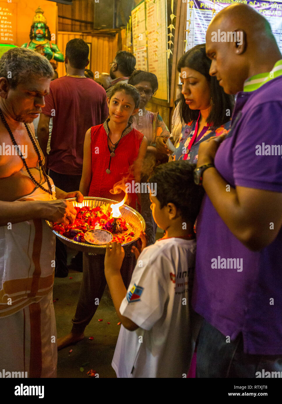 Hindu Priest with Family Performing Ritual of Touching the Lamp, Sree ...