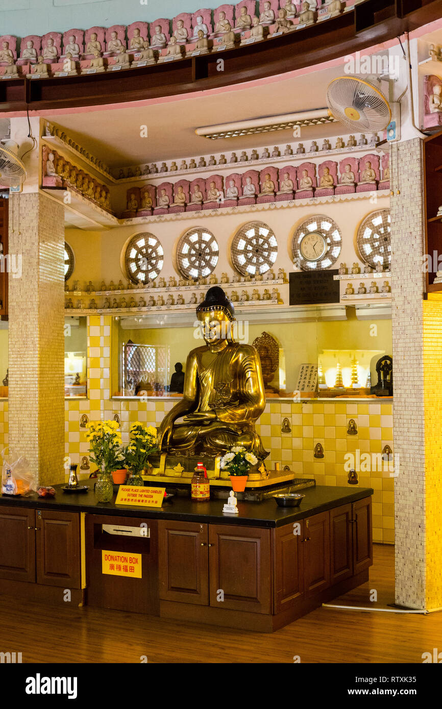Buddha Demonstrating Earth Witness (Bhumisparsha) Mudra inside the  International Buddhist Pagoda, Maha Vihara Buddhist Temple, Kuala Lumpur, Malaysia Stock Photo