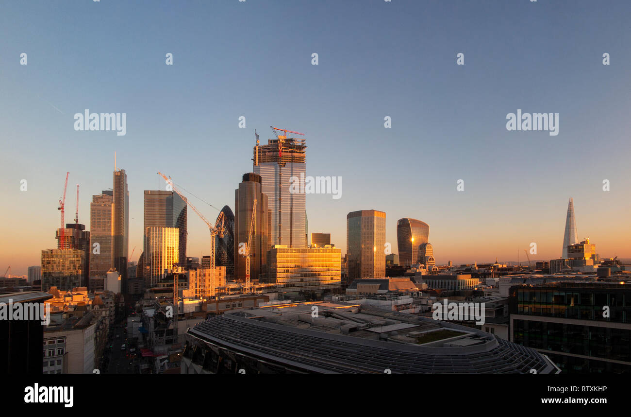 London High Rises A dramatic City of London skyline with the high rise buildings bathed ...