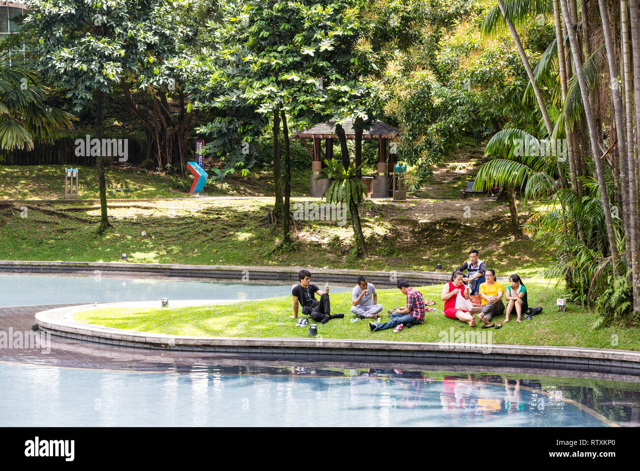 Malaysians Relaxing at KLCC Park, Kuala Lumpur, Malaysia. Stock Photo