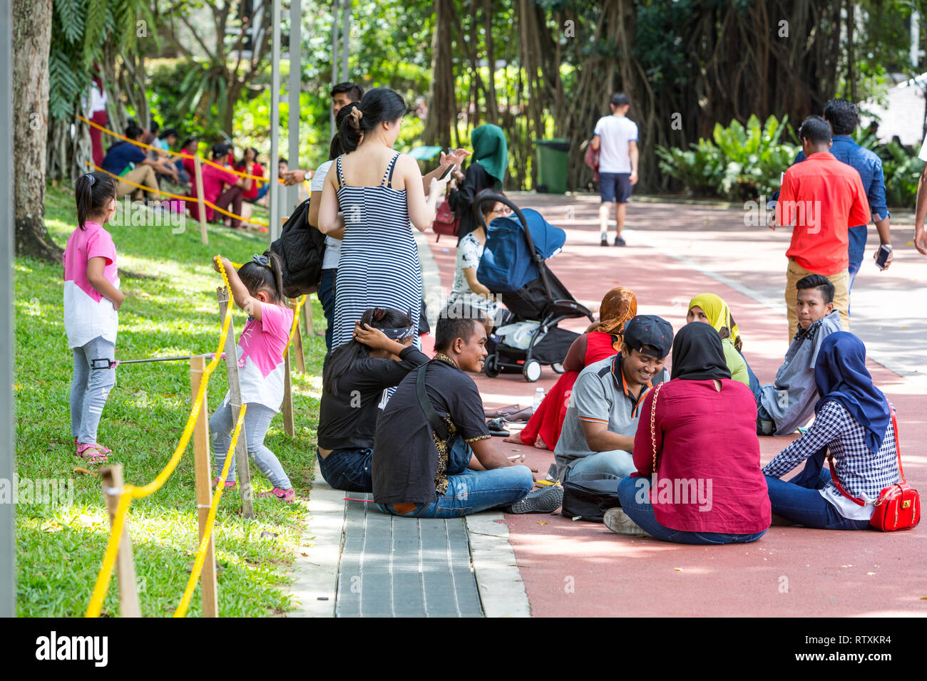 Malaysians Relaxing at KLCC Park, Kuala Lumpur, Malaysia. Stock Photo