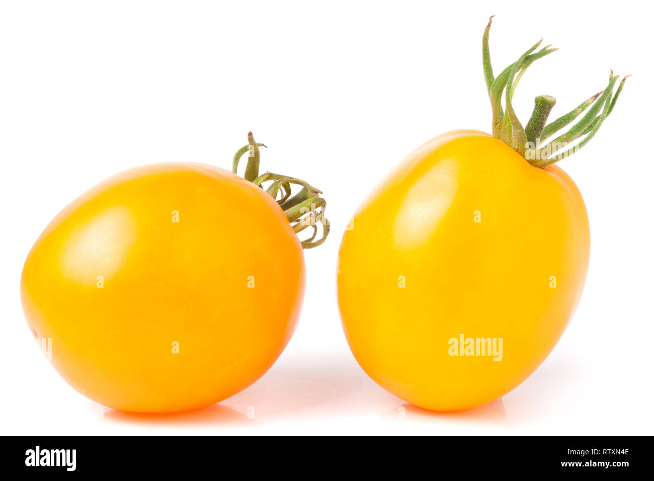 two yellow tomato isolated on white background Stock Photo - Alamy