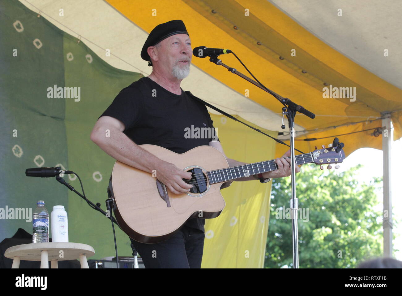 Singer, songwriter and guitarist Richard Thompson is shown performing on stage during 'live' concert appearance. Stock Photo