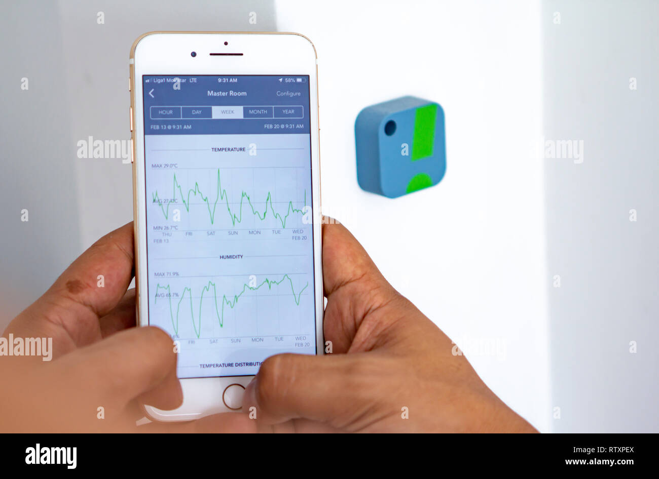 Man monitoring home humidity levels with app Stock Photo