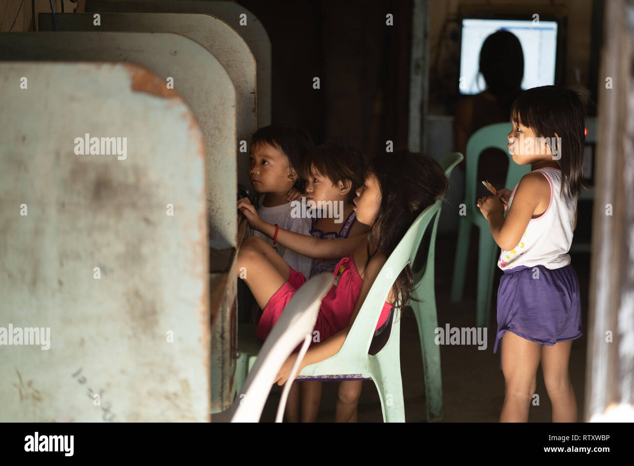 Concept image of children in third world poverty being in a vulnerable situation when using the Internet. Stock Photo