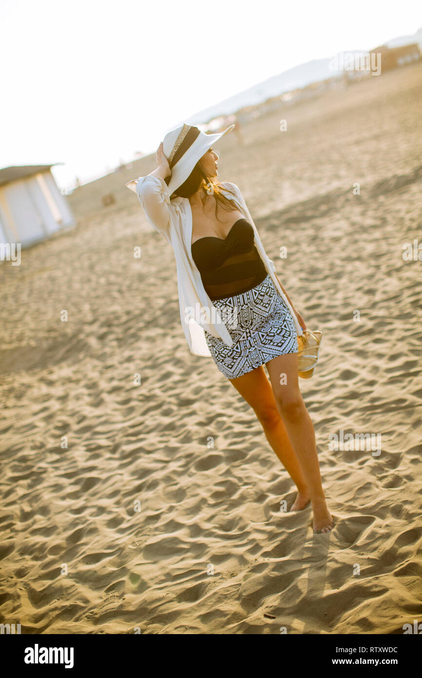 View at young woman posing on the sandy beach Stock Photo