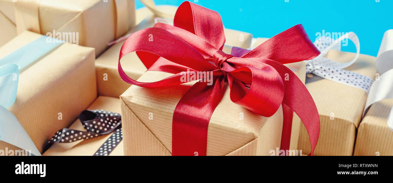 gift boxes with red and blue ribbons. long banner Stock Photo - Alamy