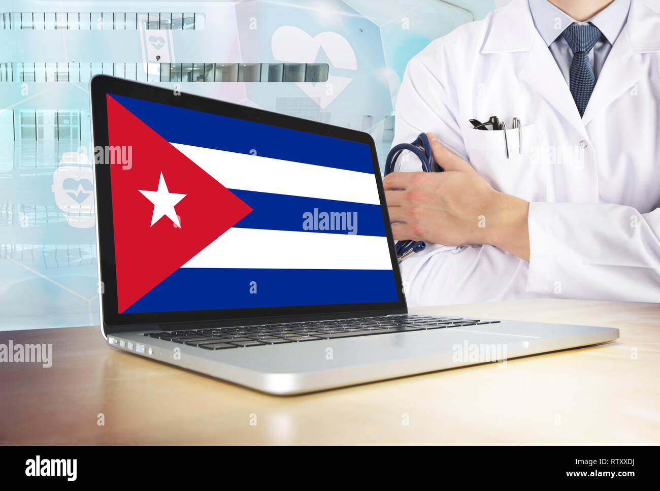 Cuba healthcare system in tech theme. Cuban flag on computer screen. Doctor standing with