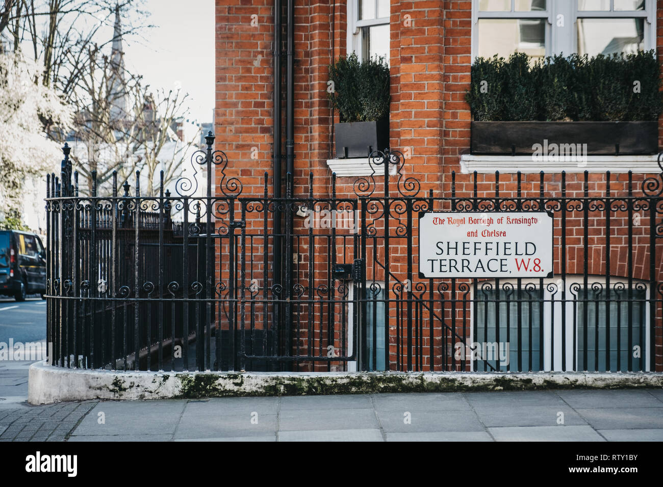 London, UK - February 23, 2019: Sheffield Terrace street name sign on a black fence in The Royal Borough of Kensington and Chelsea, an affluent area i Stock Photo