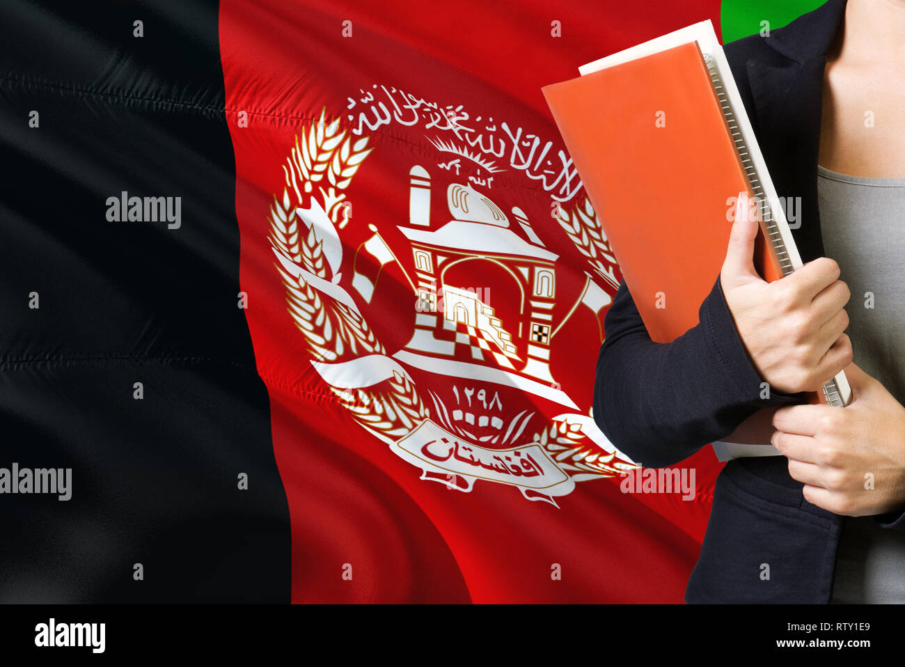 Learning Afghan language concept. Young woman standing with the Afghanistan flag in the