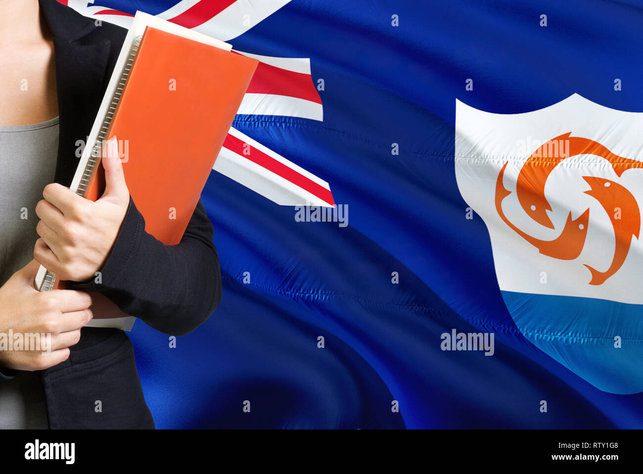 Learning Anguillian language concept. Young woman standing with the Anguilla flag in the