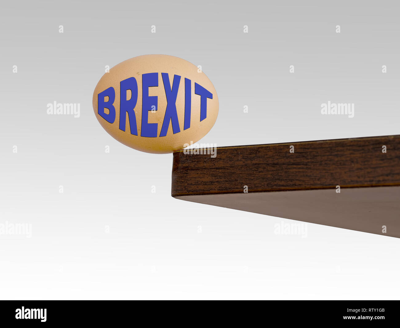 Brexit egg teetering on the edge. Brink. Risk, danger concept or metaphor. EU UK politics. Stock Photo