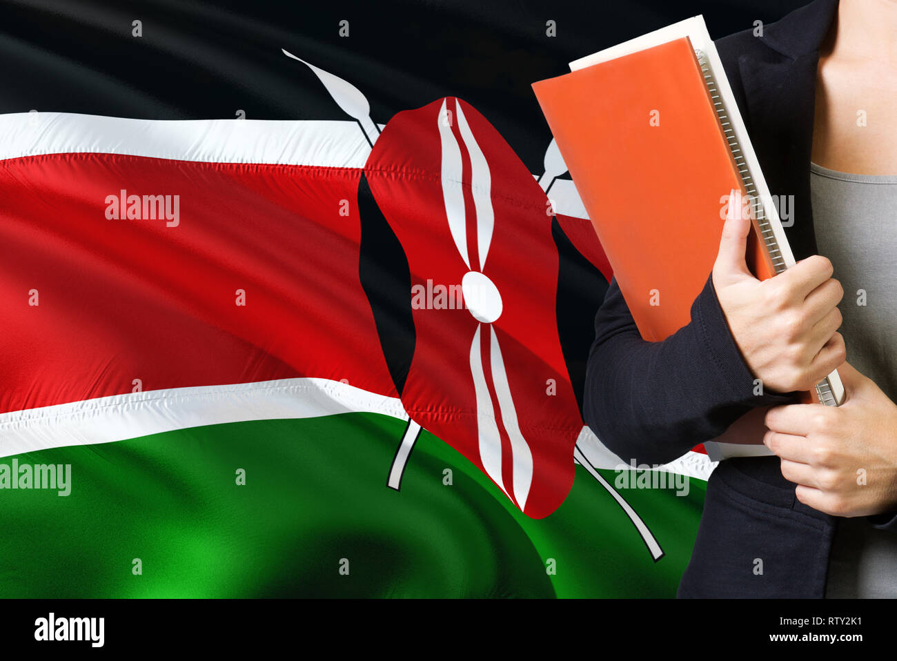 Learning Kenyan language concept. Young woman standing with the Kenya flag in the background