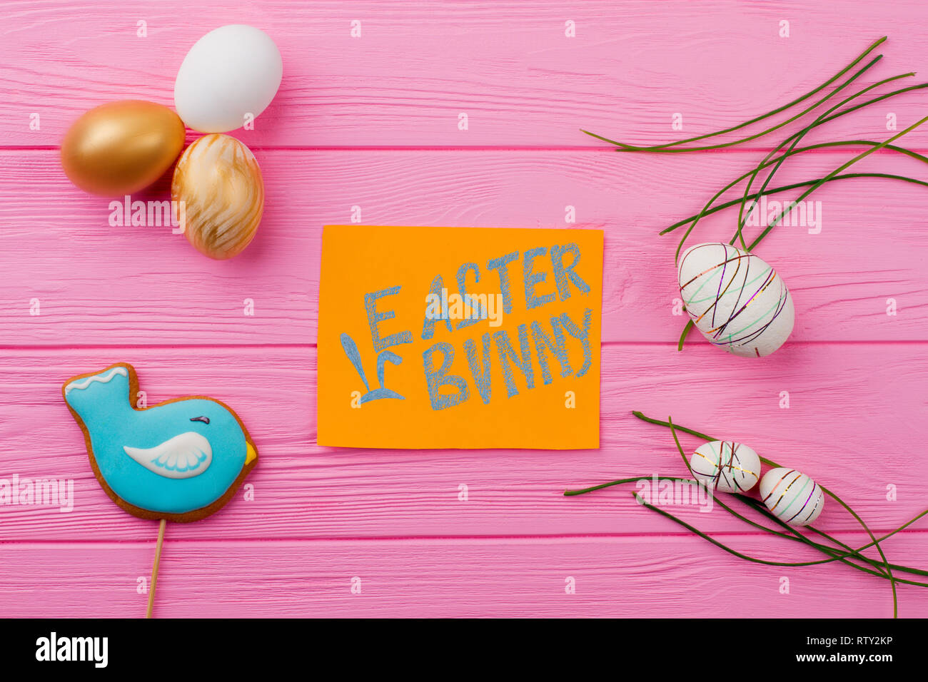 Easter festive background with decorations. Easter various eggs on pink wooden table. Easter bunny card. Creative Easter craft. Stock Photo