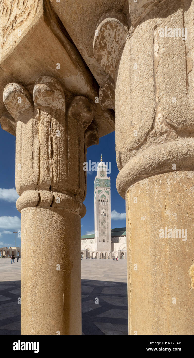 Minaret of Hassan II Mosque framed by two stone columns, Casablanca Stock Photo