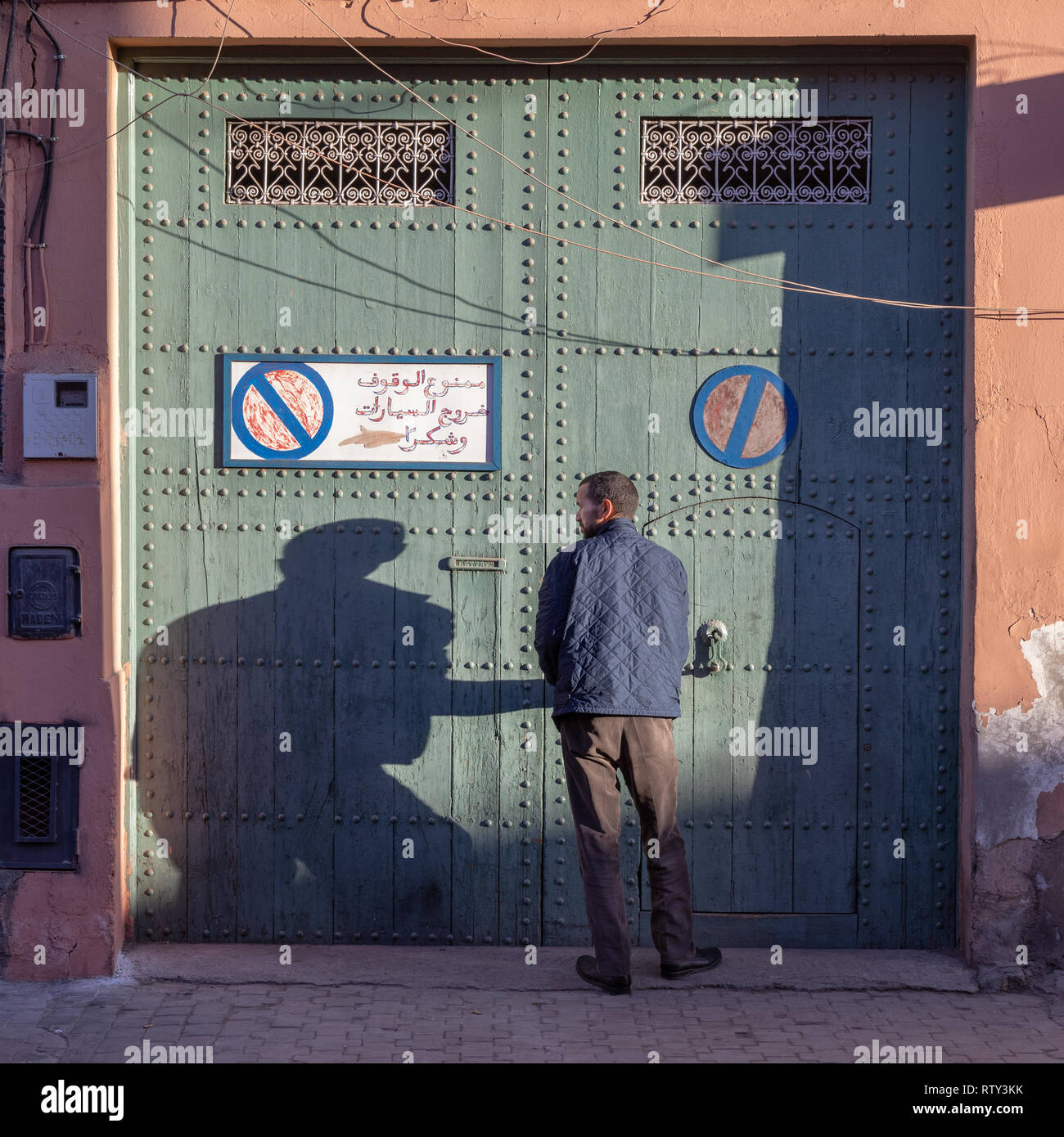 Man unlocking business in Marrakech medina Stock Photo