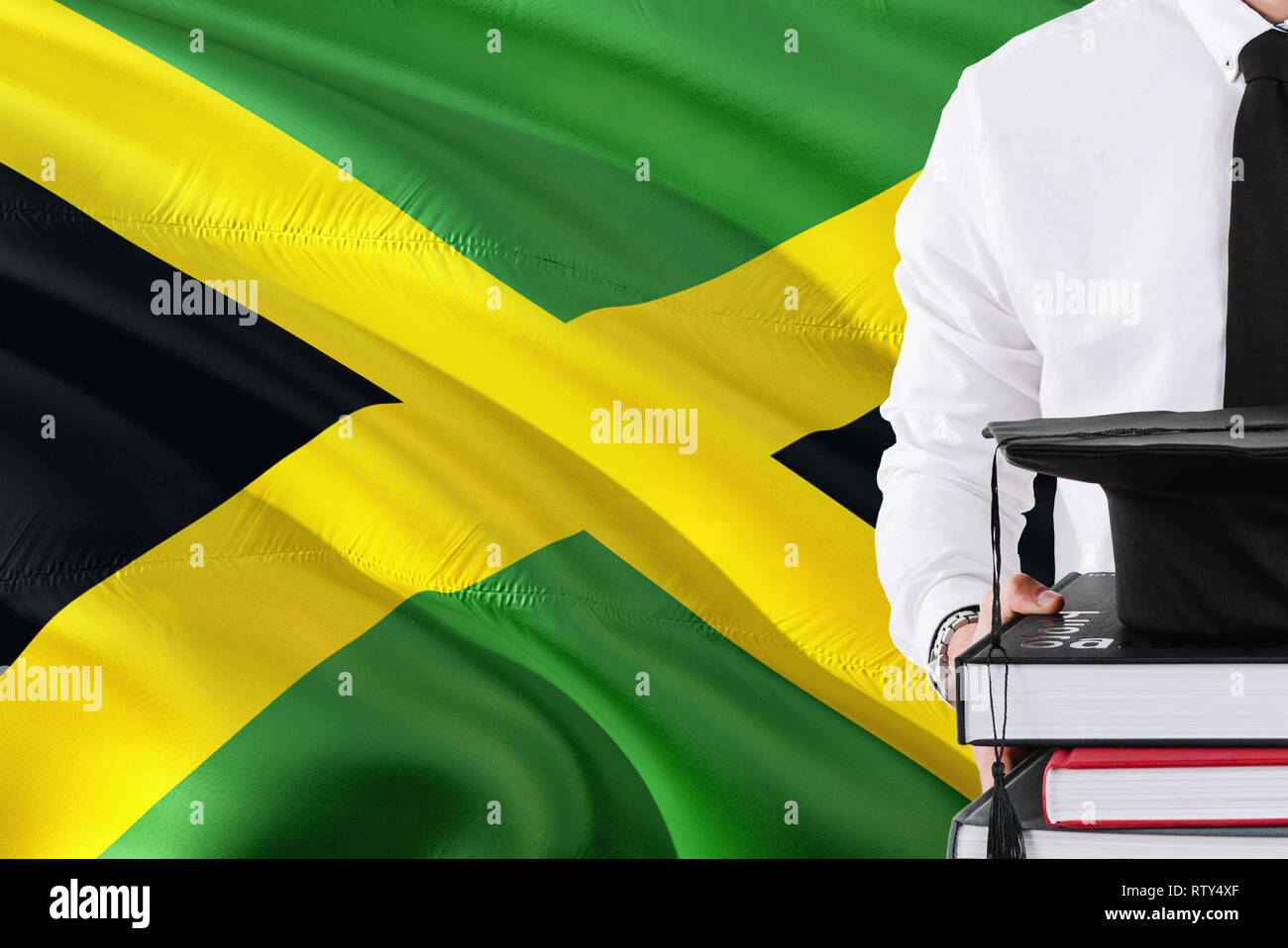 Successful Jamaican student education concept. Holding books and