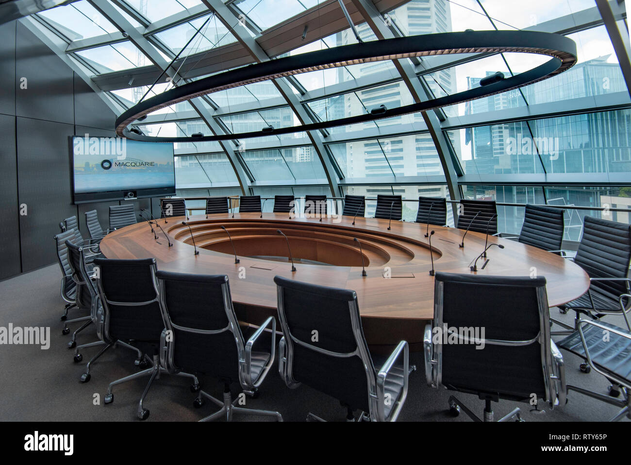 Looking through the glass roof of a board room at the Macquarie Bank owned ex Commonwealth Bank building in Martin Place, at the white MLC Centre Stock Photo