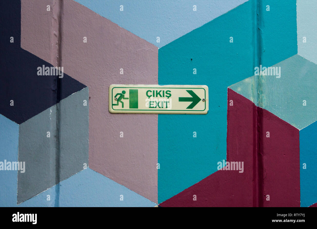 Green exit sign in Turkish language and English language with symbol of ...