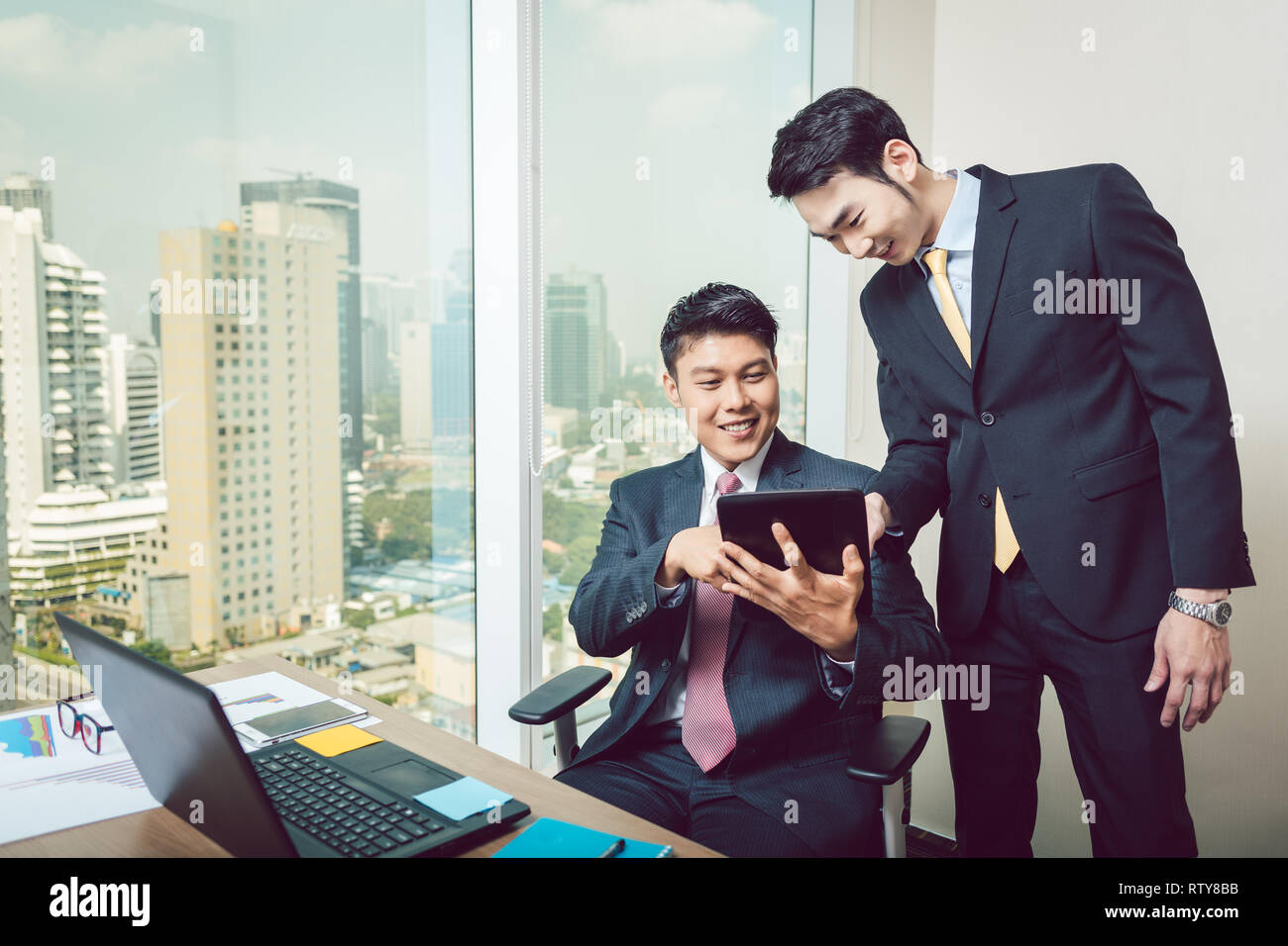 Two businessmen looking at digital tablet Stock Photo