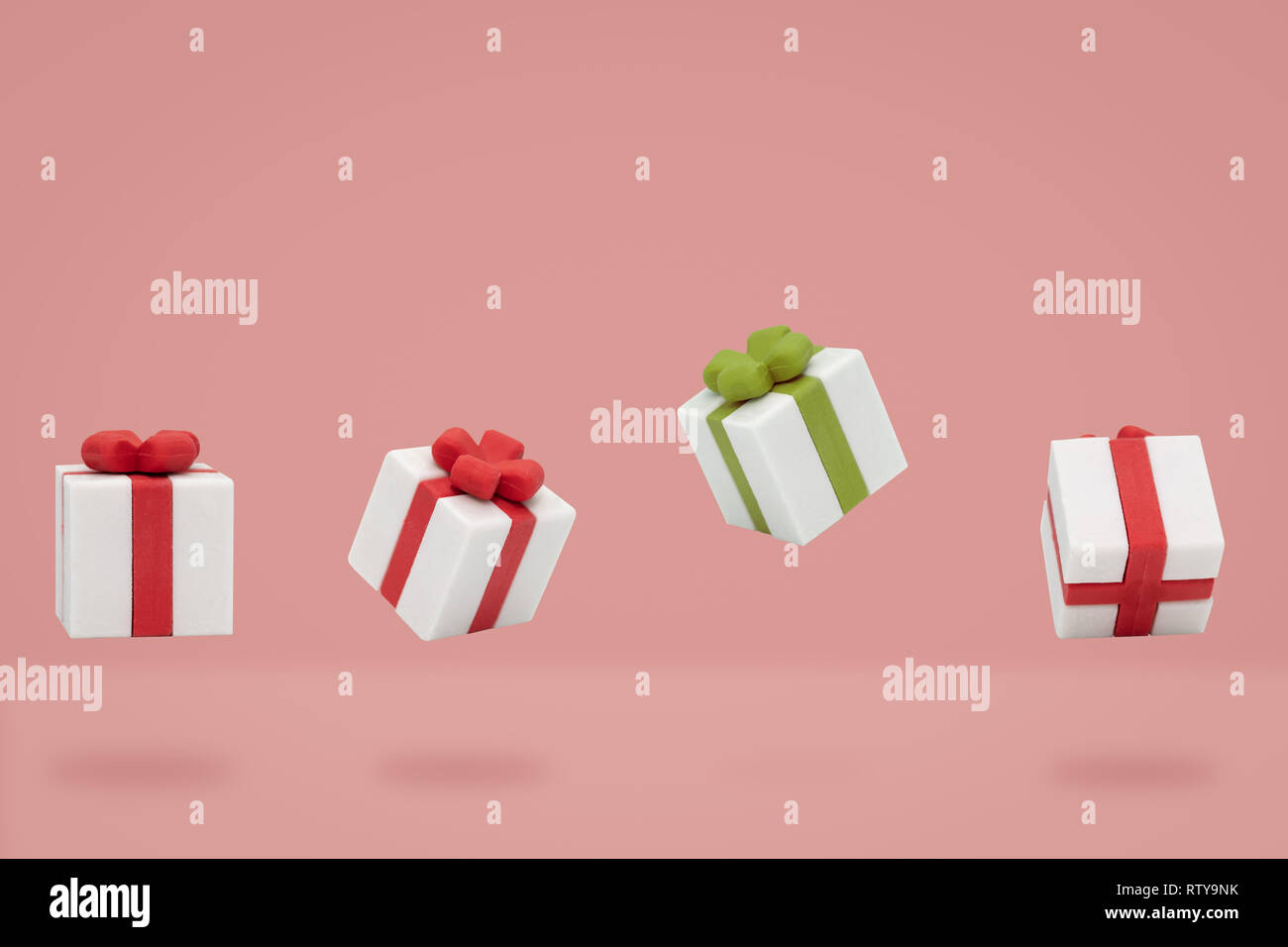 Christmas gift boxes is flying on pink backdrop, Minimal composition. Stock Photo