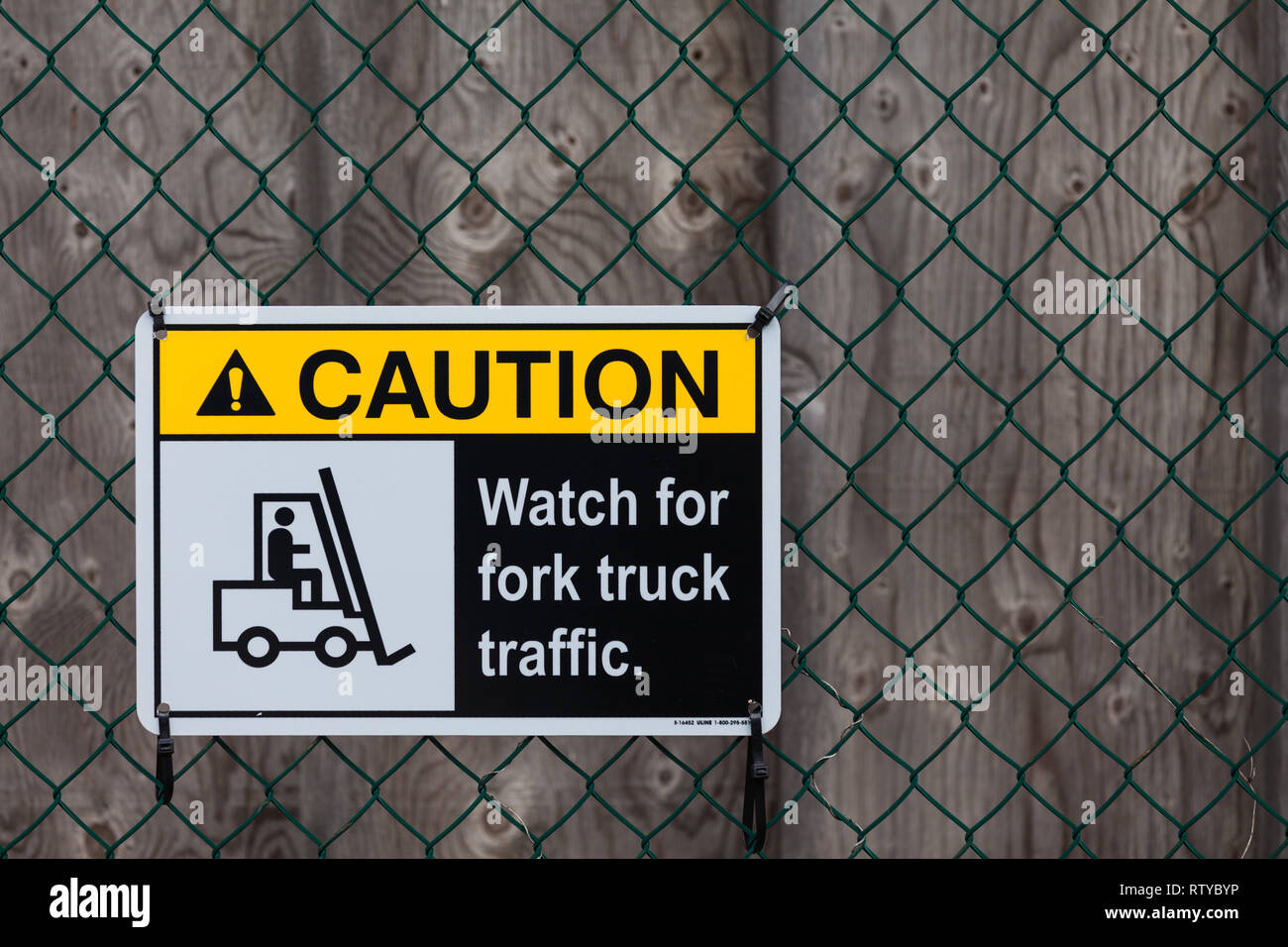 Fork lift truck warning sign secured to a fence Stock Photo