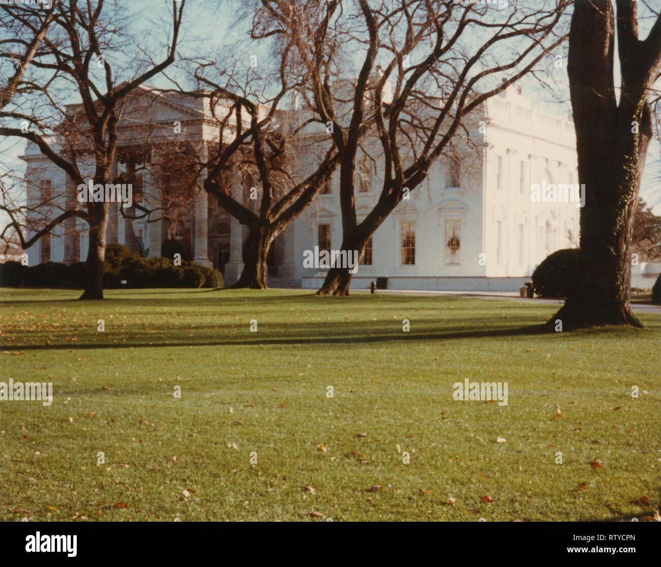 Vintage February 1985 photograph, view of the White House in Washington, DC, with a bucket truck removing the holiday garland. SOURCE: ORIGINAL PHOTOGRAPH Stock Photo