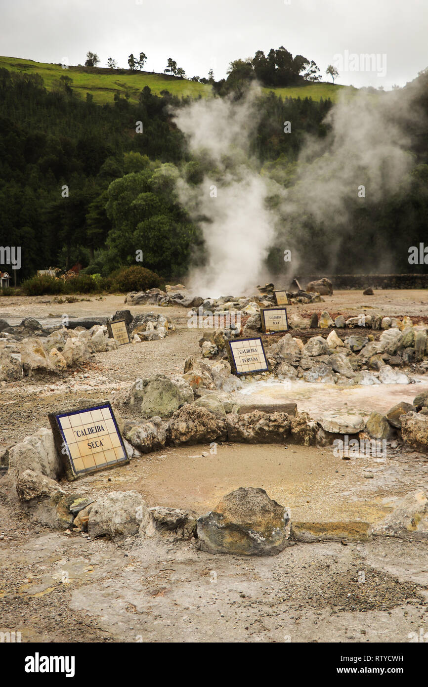 Smoking fumarole and water spring in geothermal area Stock Photo