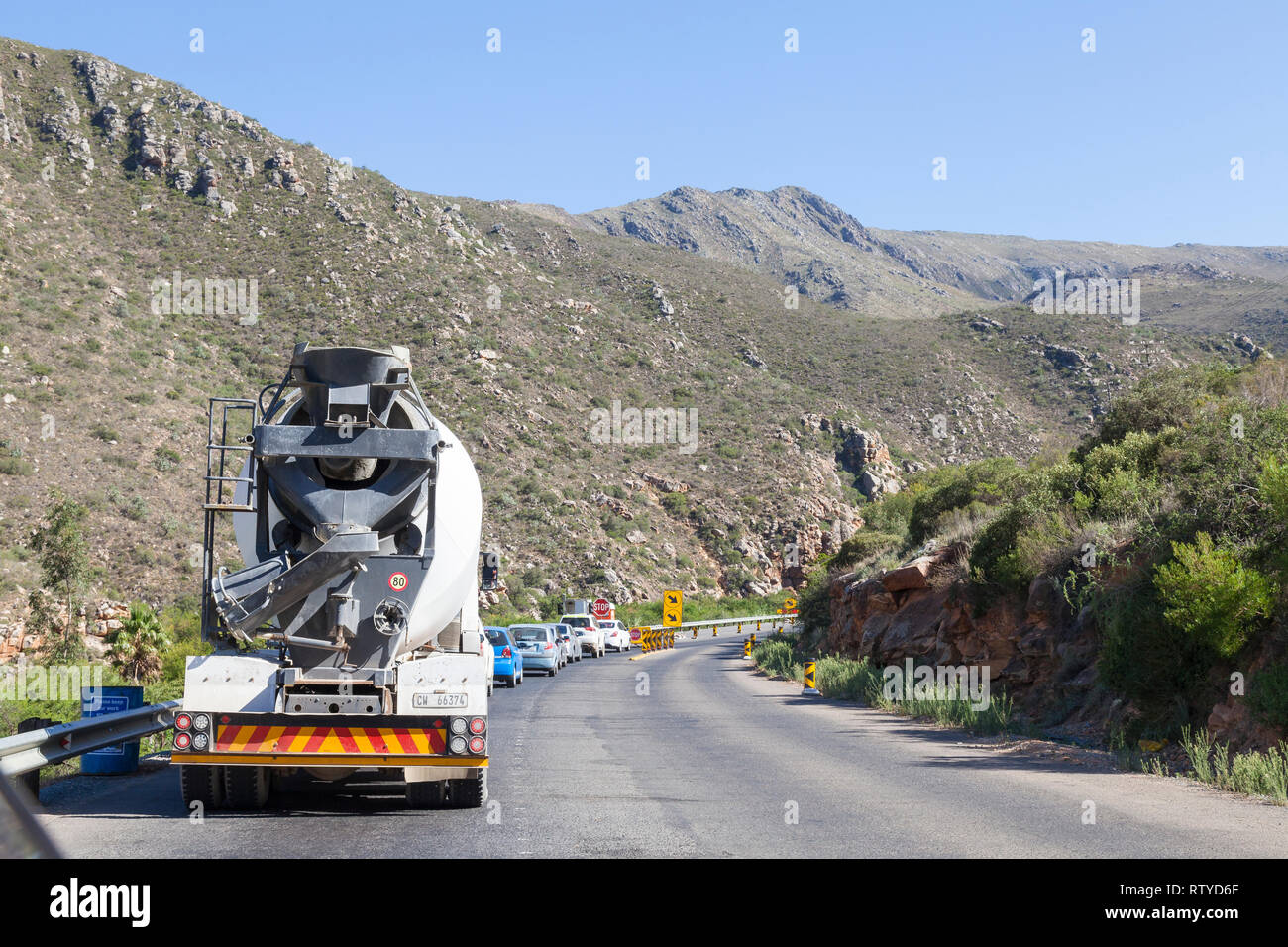 Stuck in a traffic queue at a Stop-Go control point for single lane driving due to roadworks in the Cogelmanskloof Pass, Langeberg Mountains, South Af Stock Photo