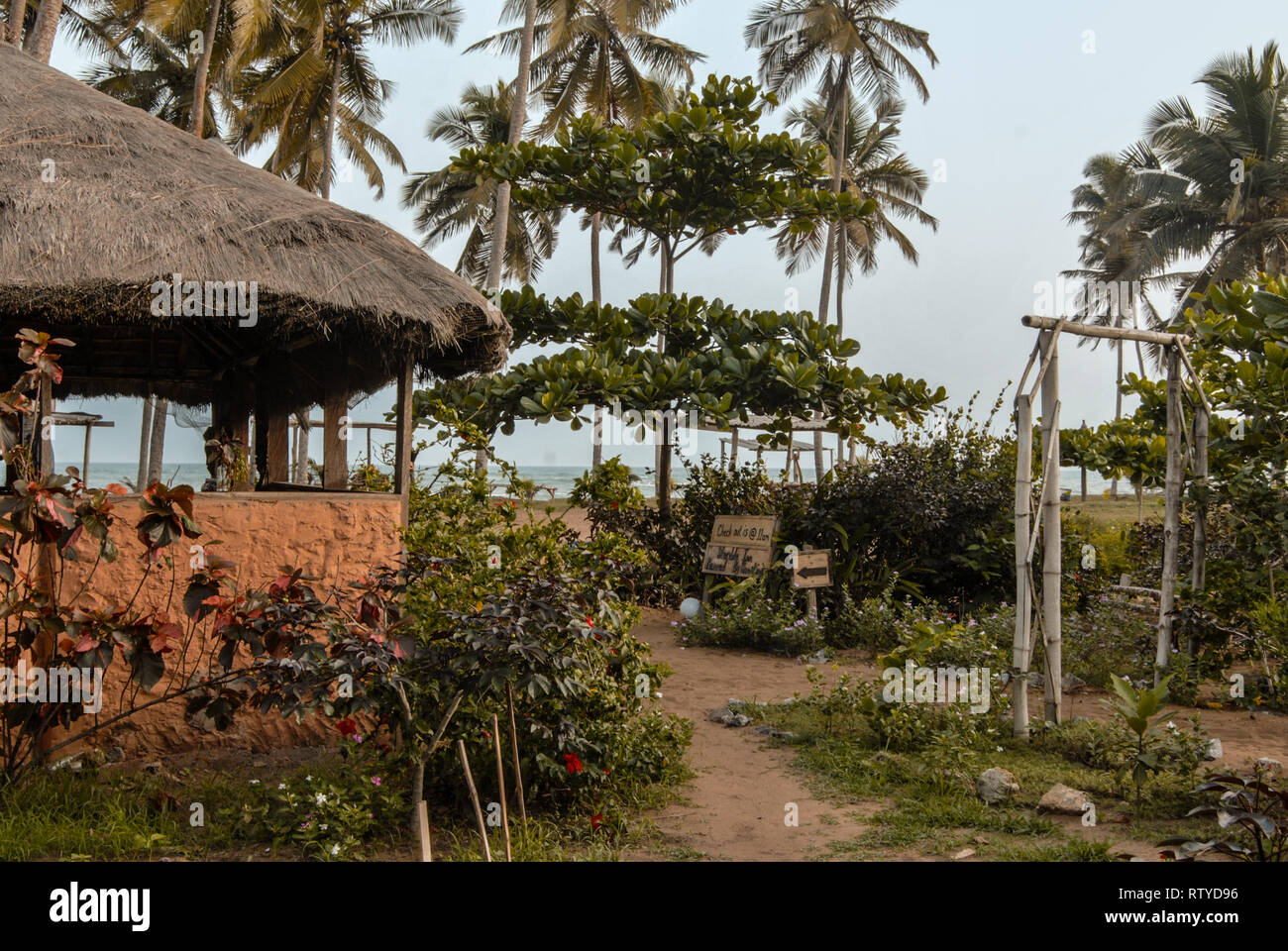 A photo of the beautiful tropical yard at the beach in Stumble inn eco lodge near Elmina, Ghana. Stock Photo