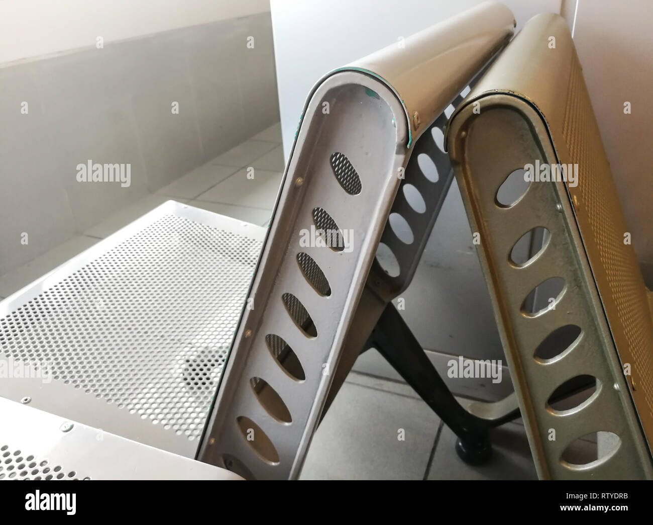 metal bench / chair at airport waiting hall Stock Photo