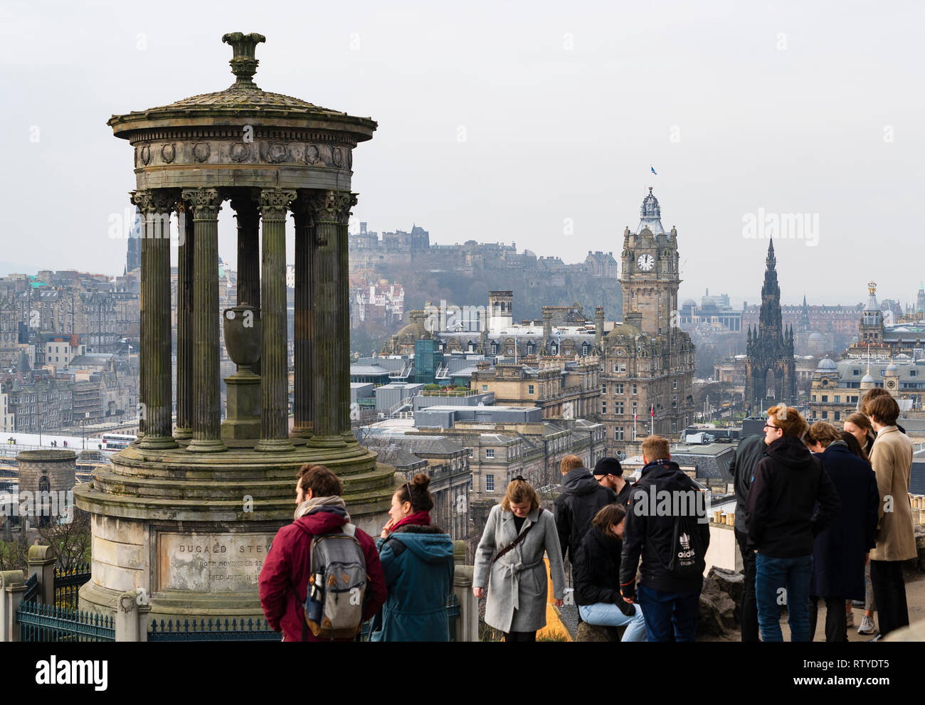 Tourists enjoying view of city of Edinburgh from Calton Hill viewpoint, Scotland, UK Stock Photo