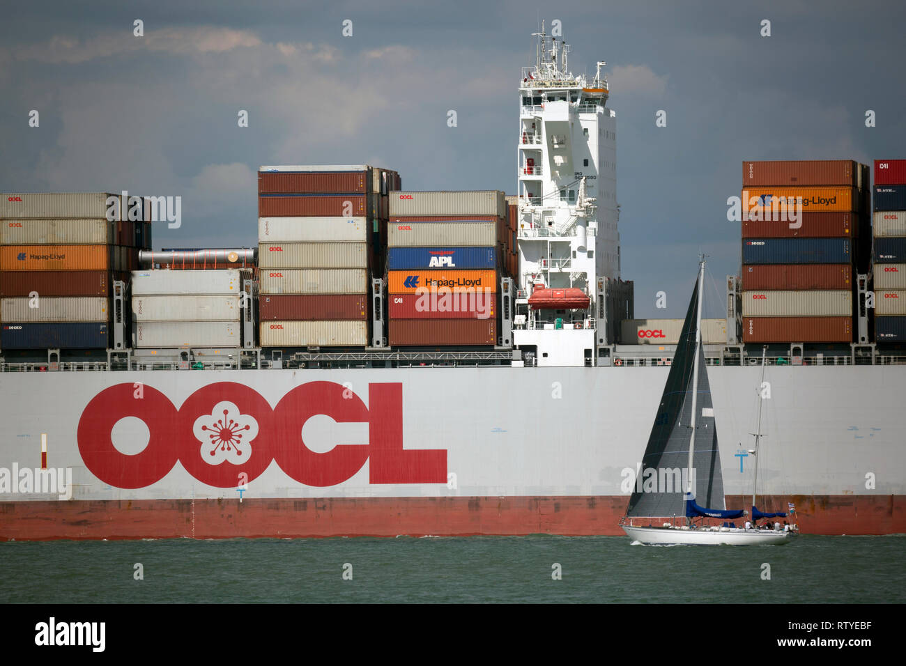 Brexit, lite,empty,Close up,OOCL, Container Ship, leaving, Southampton, Port, The Solent, Cowes, Isle of Wight, Stock Photo