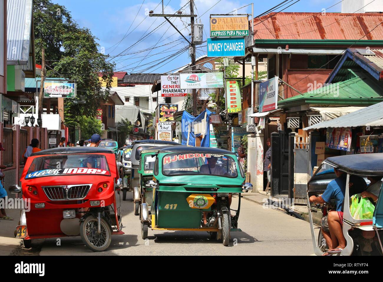 PALAWAN, PHILIPPINES DECEMBER 2, 2017 Tourists ride tricycle taxis