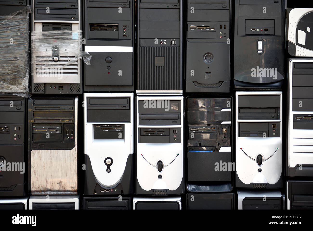 Rows of stacked, used, outdated desktop computer tower, hard drives and ...