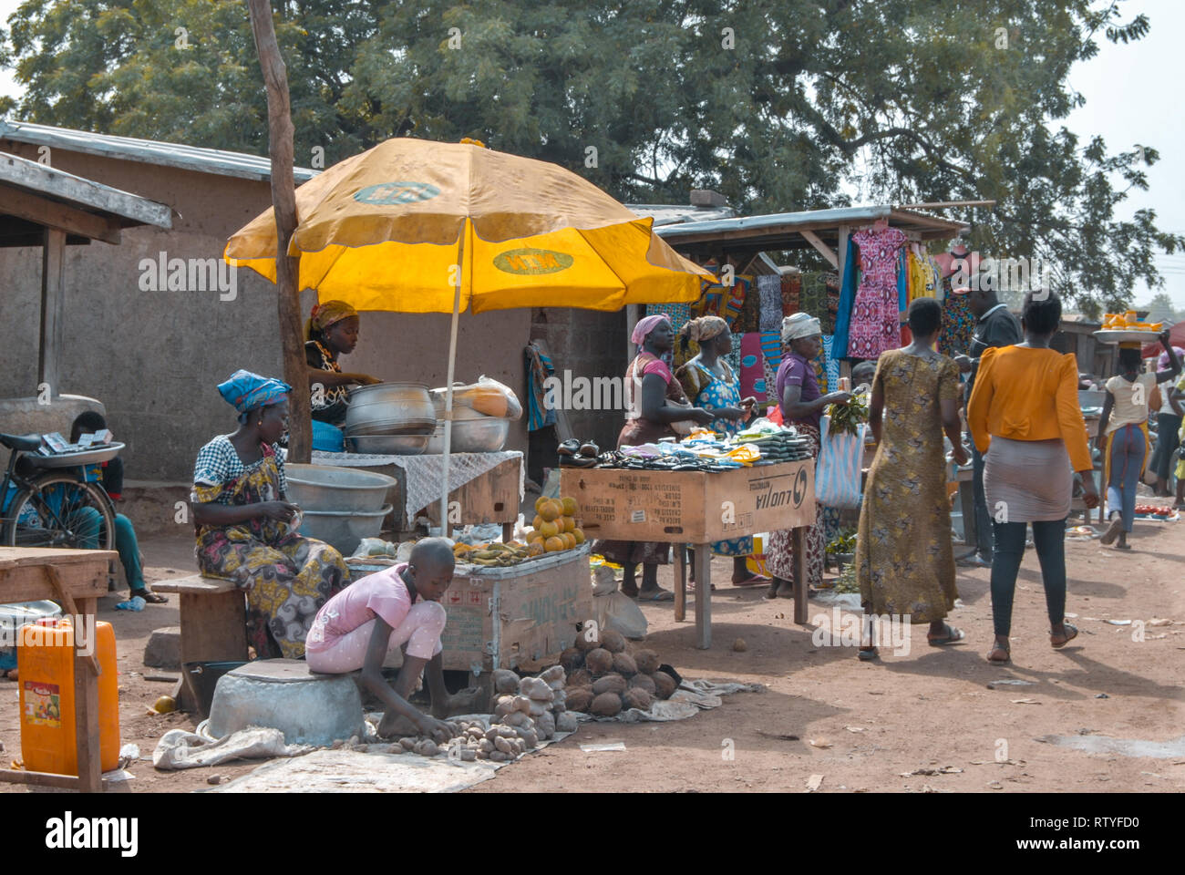 A photo of vendors selling various goods including fresh vegetables at a street in Bolgatanga (Bolga), Ghana, West Africa Stock Photo