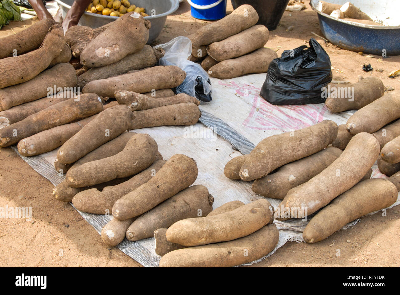 A stand of fresh manioc at Bolgatanga (Bolga) farmer's market in Ghana, West Africa. Stock Photo