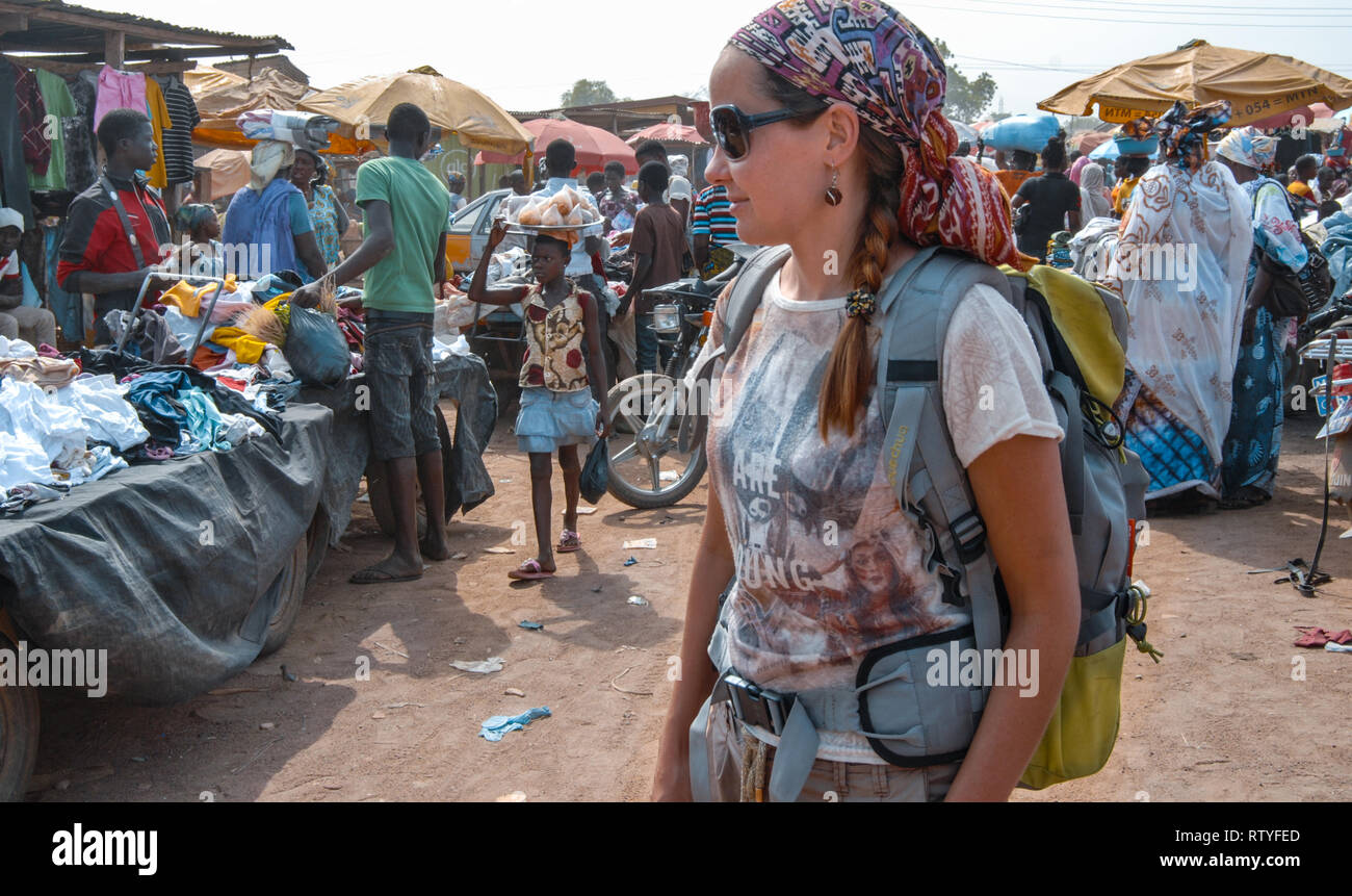 A female European backpacker visiting busy Bolgatanga market in Ghana, Western Africa Stock Photo
