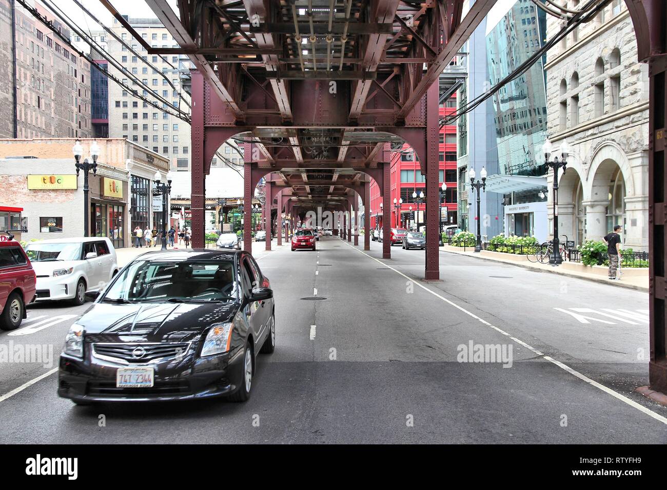 CHICAGO, USA JUNE 28, 2013 Cars drive under elevated train tracks in