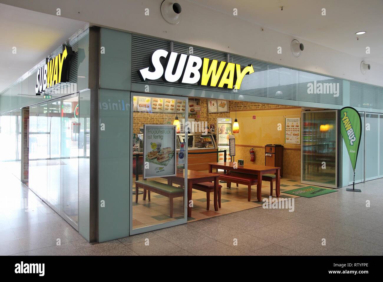 BERLIN, GERMANY - AUGUST 26, 2014: Sandwich seller waits for customers in Subway restaurant at a railway station in Berlin. Subway has 44,852 restaura Stock Photo