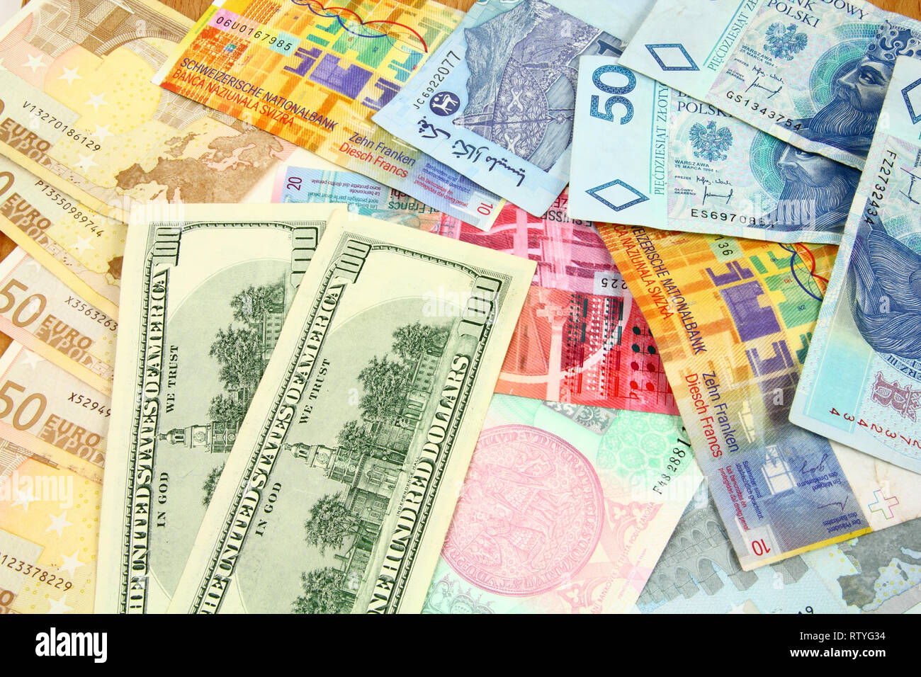 World finance and foreign currency exchange concept - money background with US dollars, Swiss franks, Polish zloty, Euros, Malaysian ringgits and Czec Stock Photo