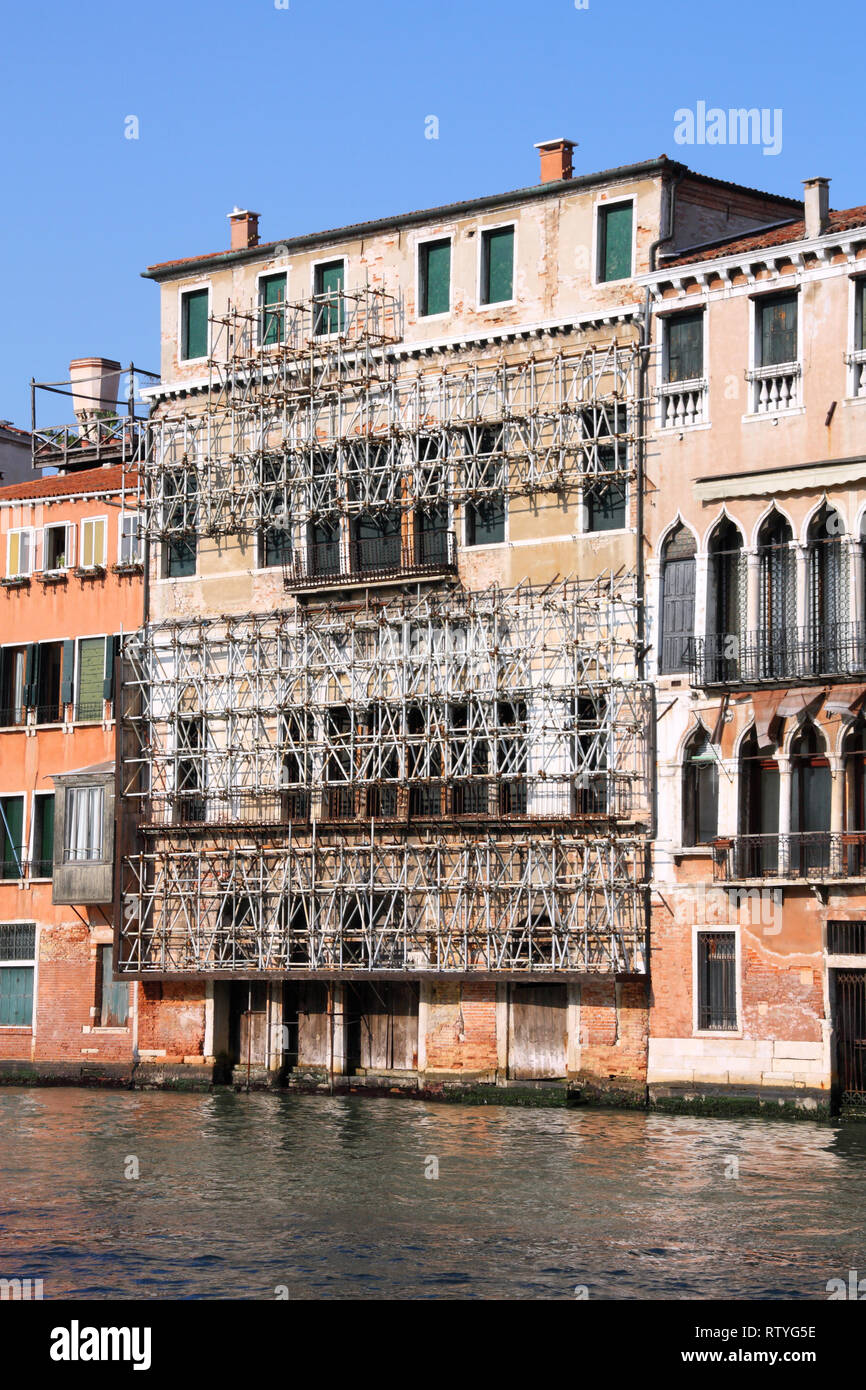 Venice, Italy. Safety scaffolding on old architecture, water canal and