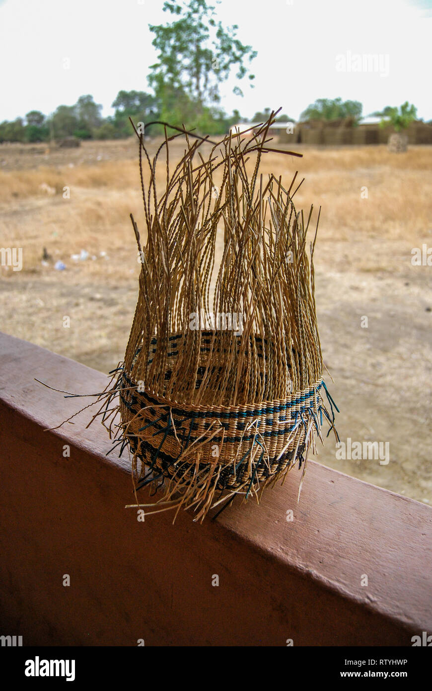 A photo of a half finished handwoven Bolga market basket made of colored elephant grass (vera veta). Stock Photo