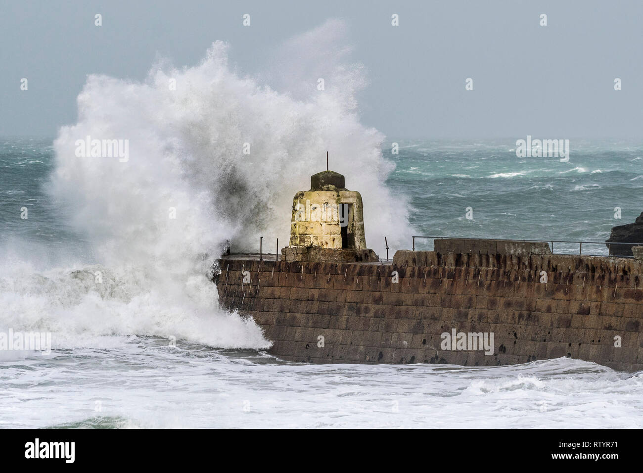 Portreath, Cornwall, UK. 3rd March, 2019.  Storm Freya swept into the Cornish coast.  The historic Monkey Hut on the pier at Portreath bravely withstood the high seas, driving wind and damaging waves.  Gordon Scammell/Alamy Live News. Stock Photo