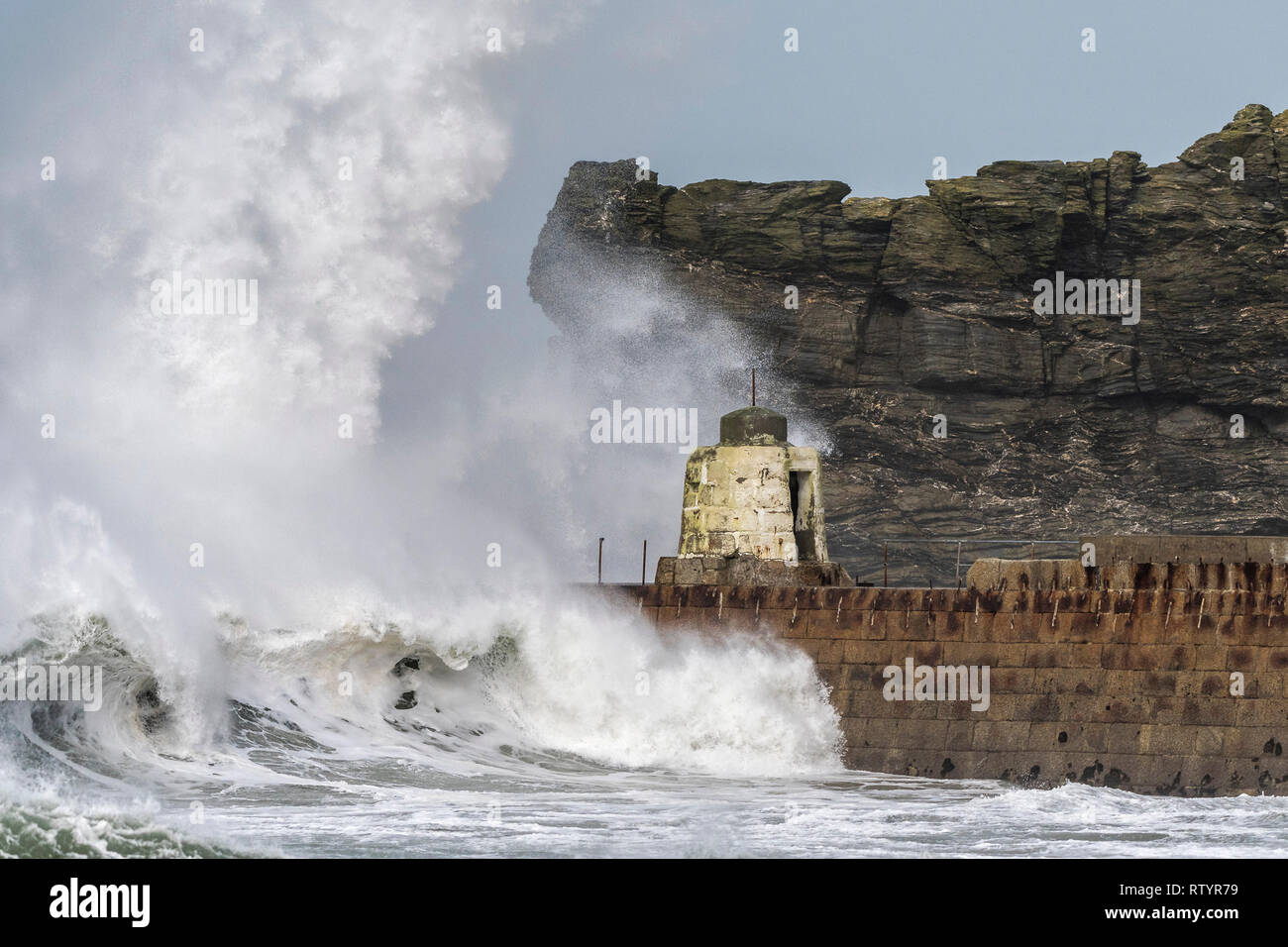 Portreath, Cornwall, UK. 3rd March, 2019.  Storm Freya swept into the Cornish coast with a vengeance.  The historic Monkey Hut on the pier at Portreath bravely withstood the high seas, driving wind and powerful waves but stronger winds are predicted later in the day.  Gordon Scammell/Alamy Live News. Stock Photo