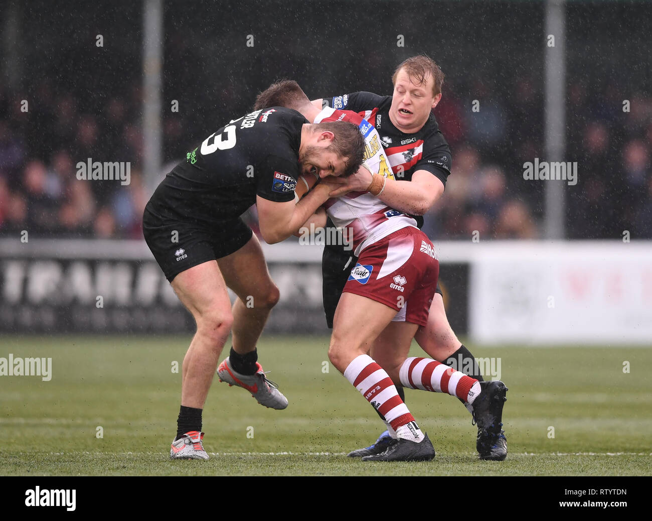 Trailfinders Sports Ground, London, UK. 3rd Mar, 2019. Betfred Super League rugby, London Broncos versus Wigan Warriors; Eddie Battye and Robert Butler of London Broncos tackle Oliver Gildart of Wigan Warriors Credit: Action Plus Sports/Alamy Live News Stock Photo