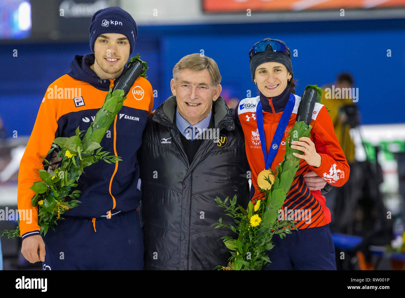 CALGARY, Olympic Oval, 04-03-2019 , season 2018 / 2019 , World Allround Speedskating Championships.  world champions Patrick Roest (L) and Martina Sablikova (r) with ISU president Jan Dijksma (M)   during WC Allround 3 March Stock Photo