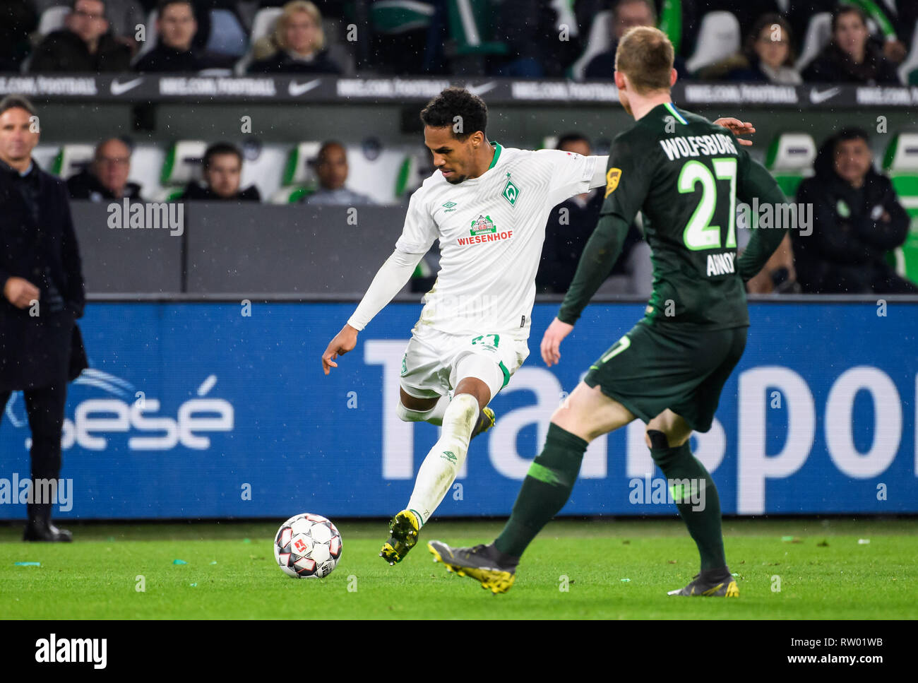 Wolfsburg, Germany. 3rd Mar, 2019. Bremen's Theodor Gebre Selassie (L)  passes the ball during a German Bundesliga match between VfL Wolfsburg and  SV Werder Bremen, in Wolfsburg, Germany, on March 3, 2019.