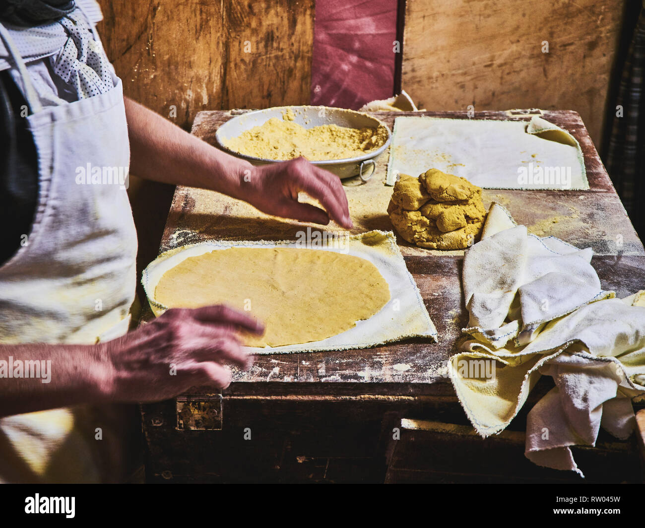https://c8.alamy.com/comp/RW045W/a-cook-making-tortillas-on-a-wooden-rustic-table-RW045W.jpg